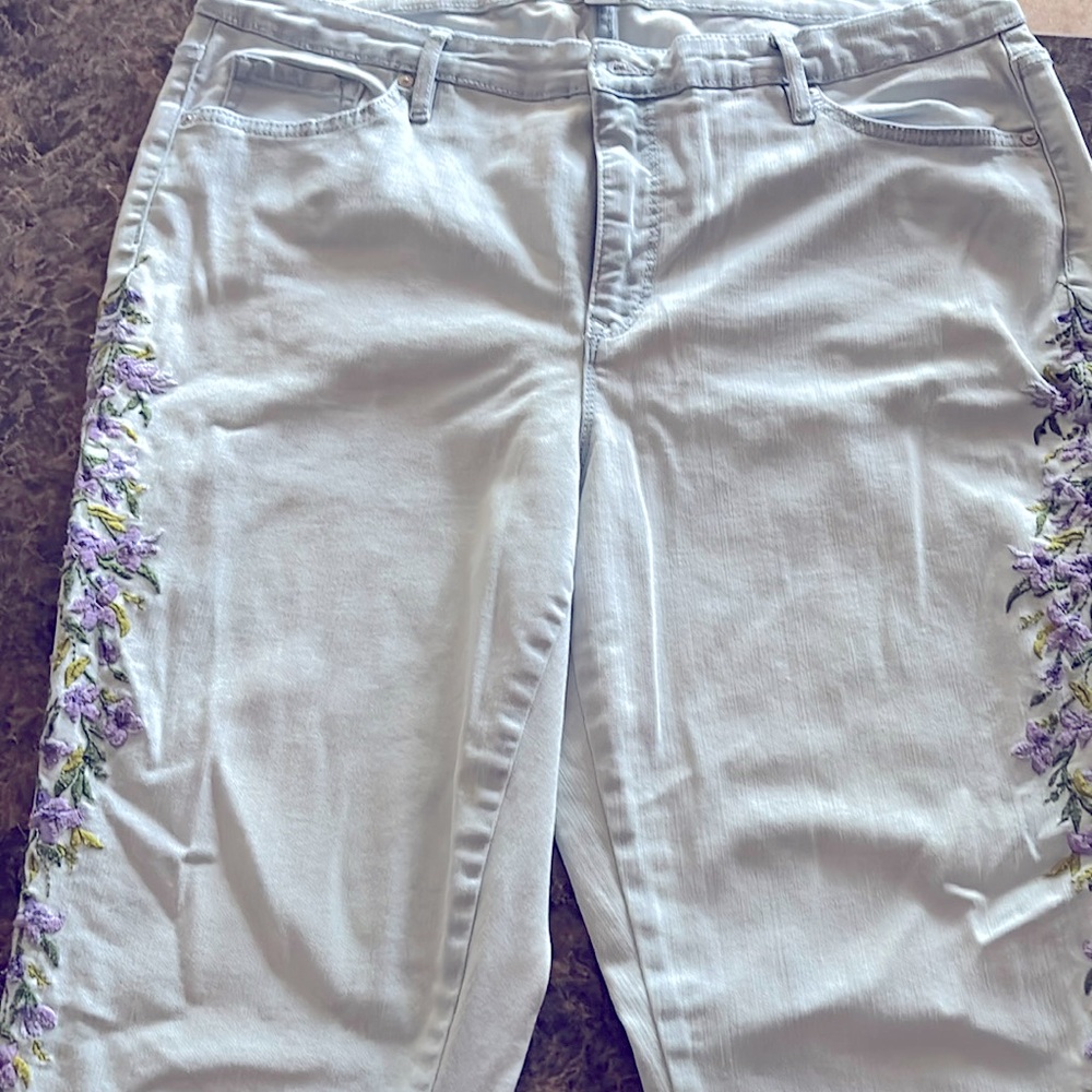 Absolutely gorgeous! Jeans are embroidered with purple flowers on each leg.